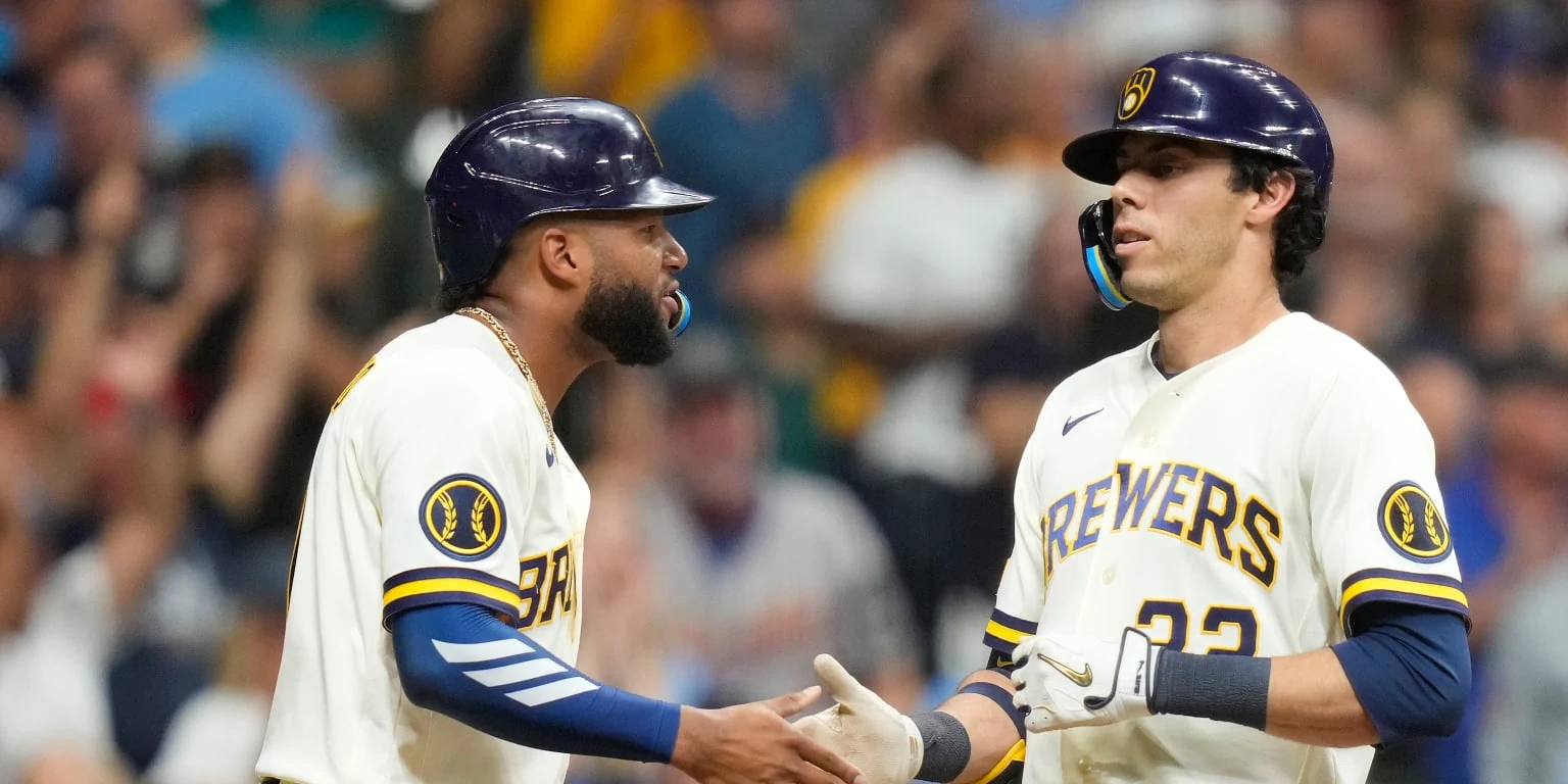 Two Milwaukee Brewers players celebrate together during an August 2026 game